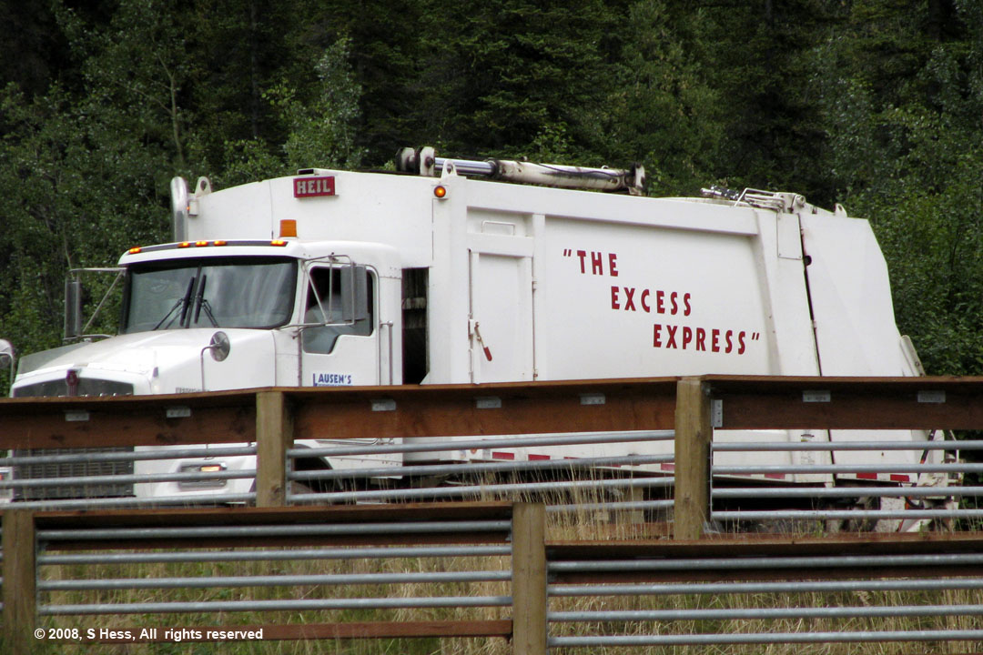 Sanitation truck with sign, "The Excess Express"